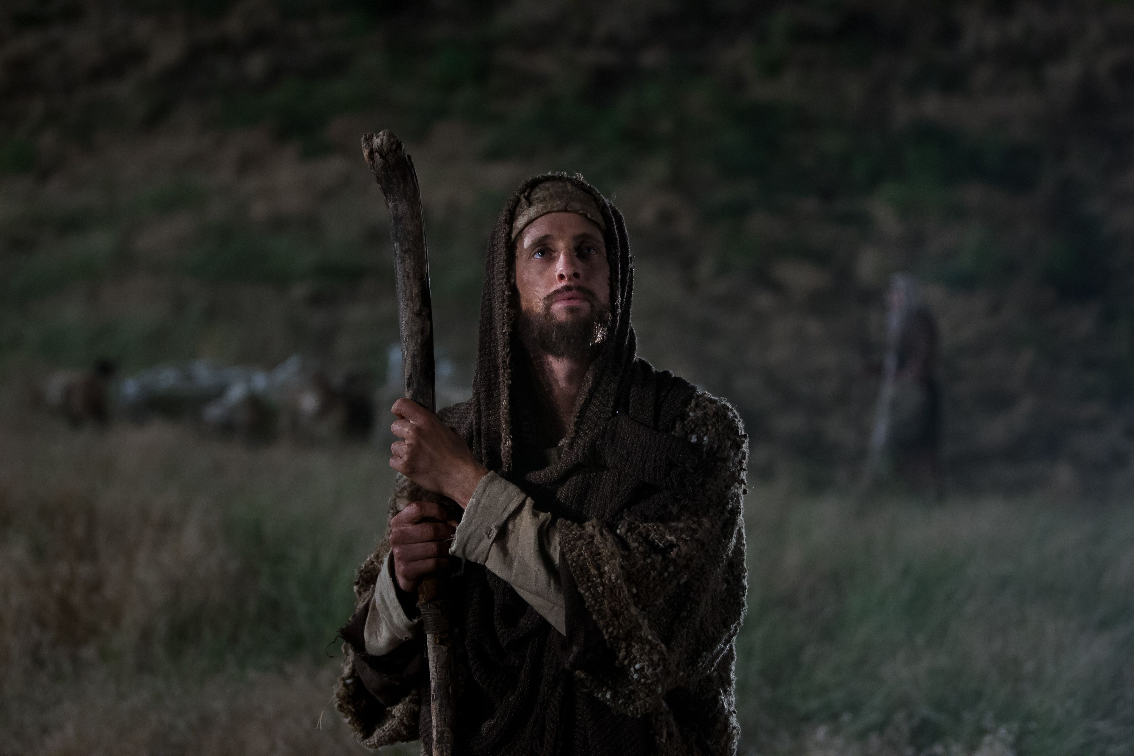 A shepherd looks toward the angel Gabriel.