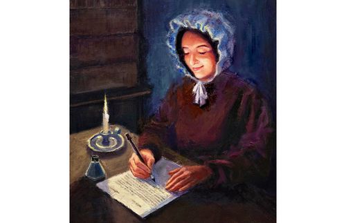 woman writing a letter by candlelight