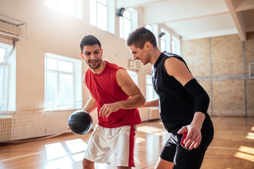 Two men playing basketball