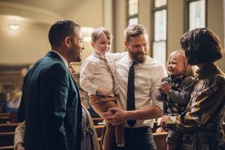 Church members talking in a chapel.