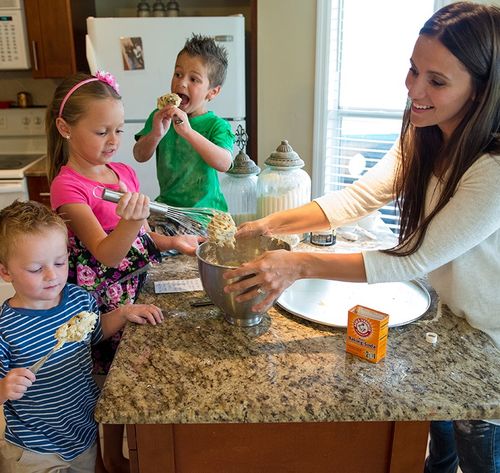 mother baking with children in kitchen