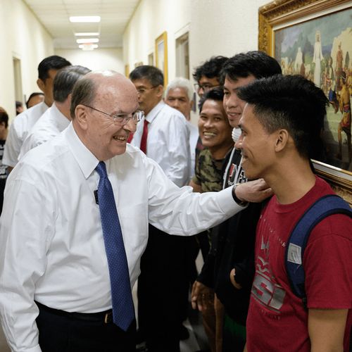 Quentin L. Cook with young people