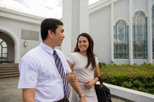 couple walking by Manila Philippines Temple