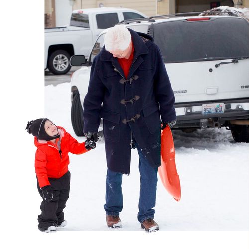 woman walking with child in snow