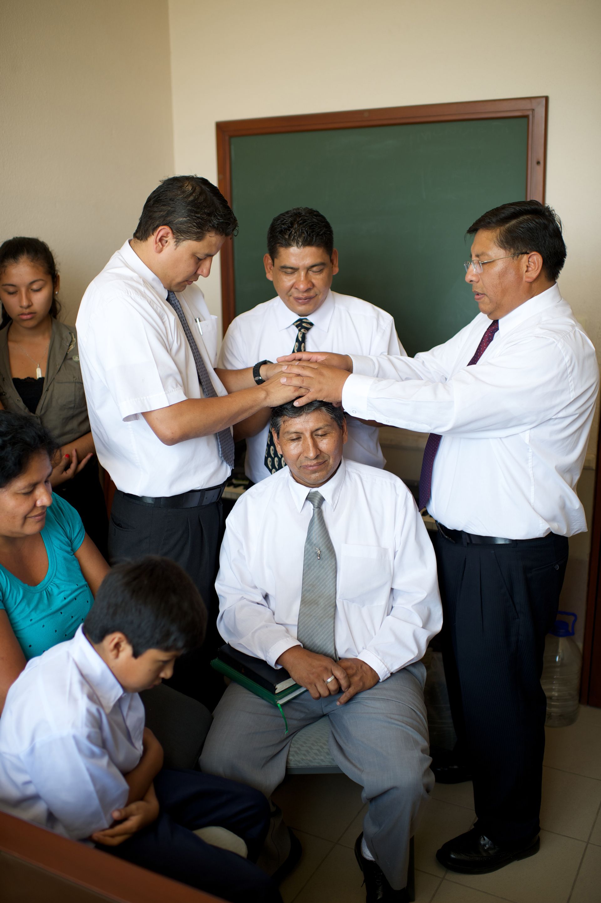 A man receiving a priesthood blessing in Bolivia.