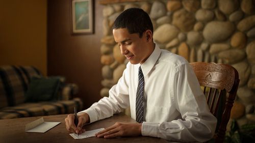 young man preparing tithing slip