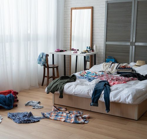 messy bedroom with curtains