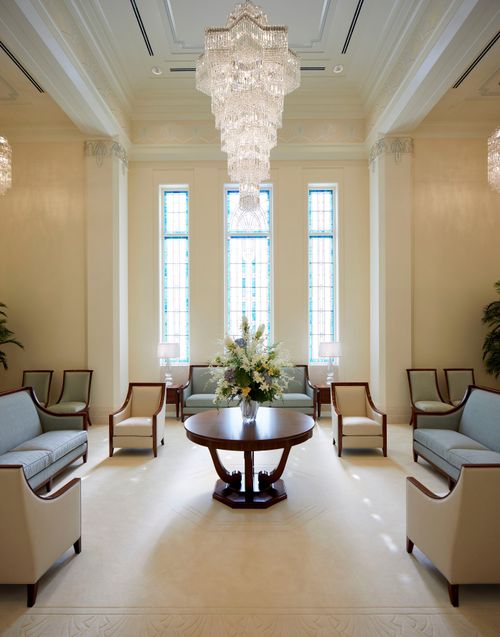 beautiful room with chandelier and tall windows