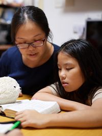 mother and daughter reading scriptures