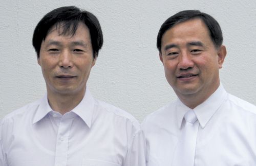 Elder Yoon Hwan Choi with another man.  Both are dressed in white.