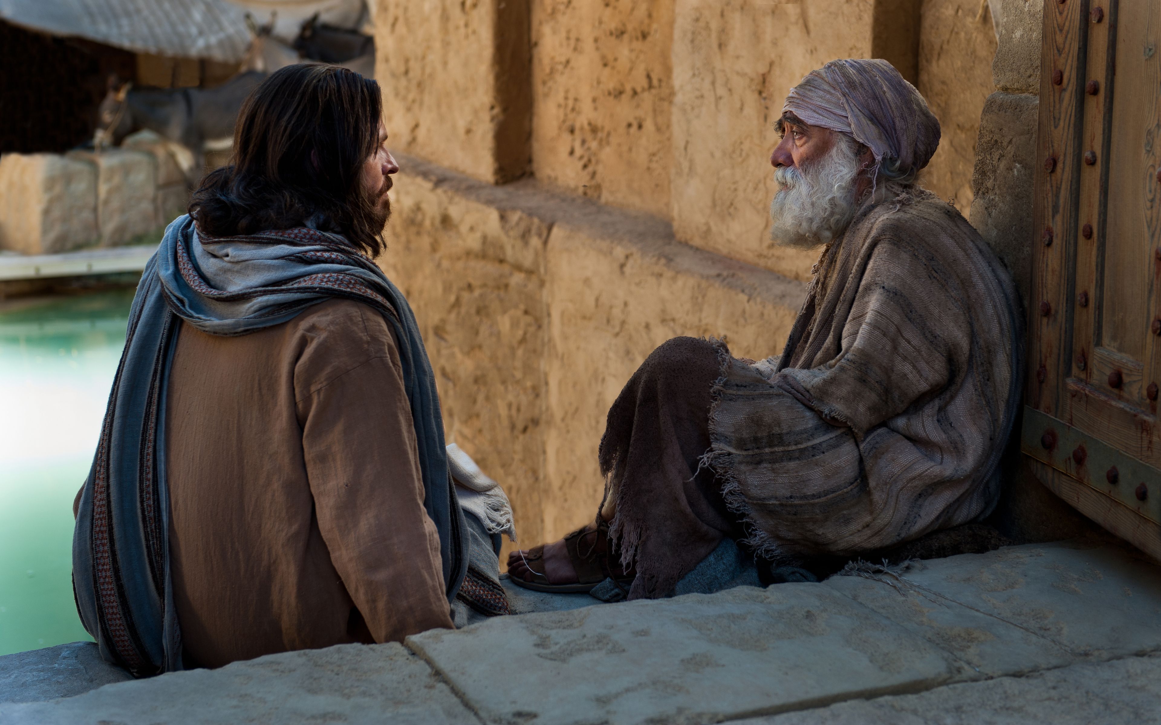 Christ speaking with a disabled man on the stairs of the pool of Bethesda.