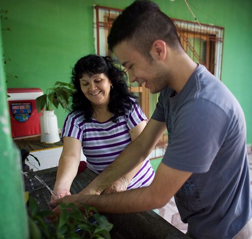 two people cleaning a house