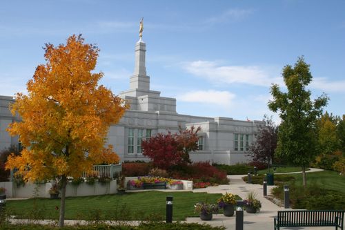 The entrance to the Regina Saskatchewan Temple, with a view of the path leading to the door and the trees changing colors on the grounds of the temple.