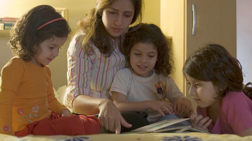 woman reading to children