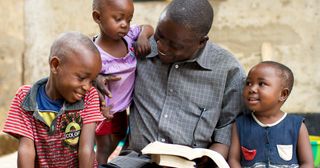 a father teaches his children from the scriptures