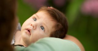 a baby looks up at her mother