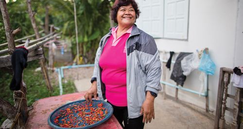 woman smiling with chilies