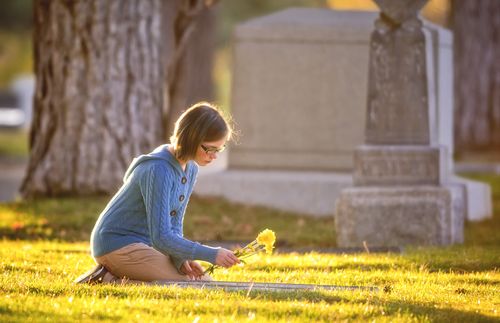 young woman visiting a cemetery