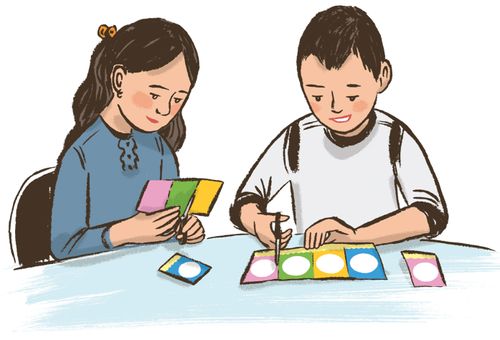 girl and boy cutting out cards