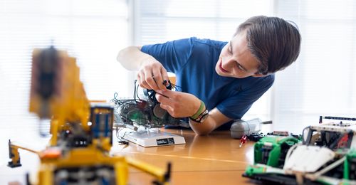 young man with model car engine