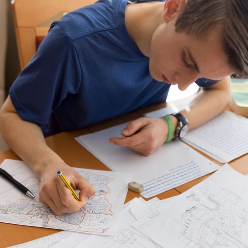 young man drawing and writing