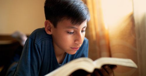 A Bolivian boy reading scriptures.