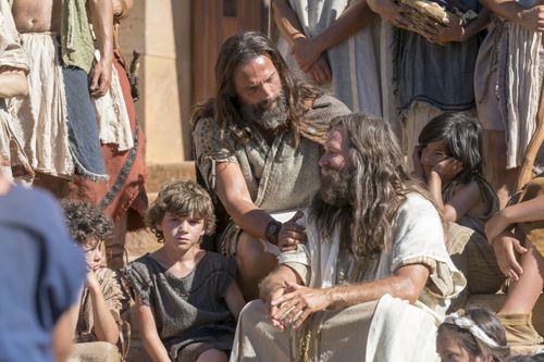 Nephi and Jacob sit on the steps of the temple, surrounded by the Nephites.