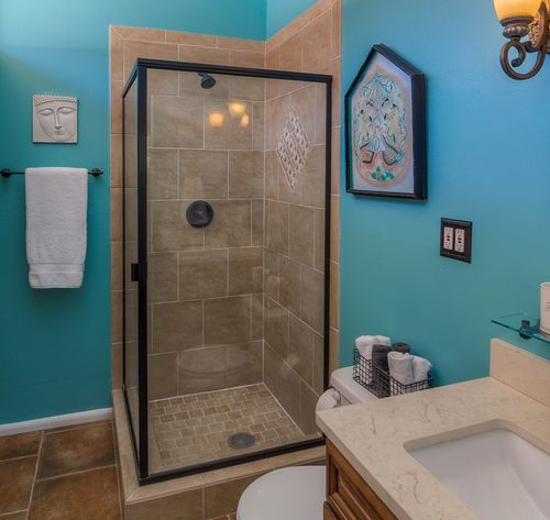 bathroom with blue tile and shower