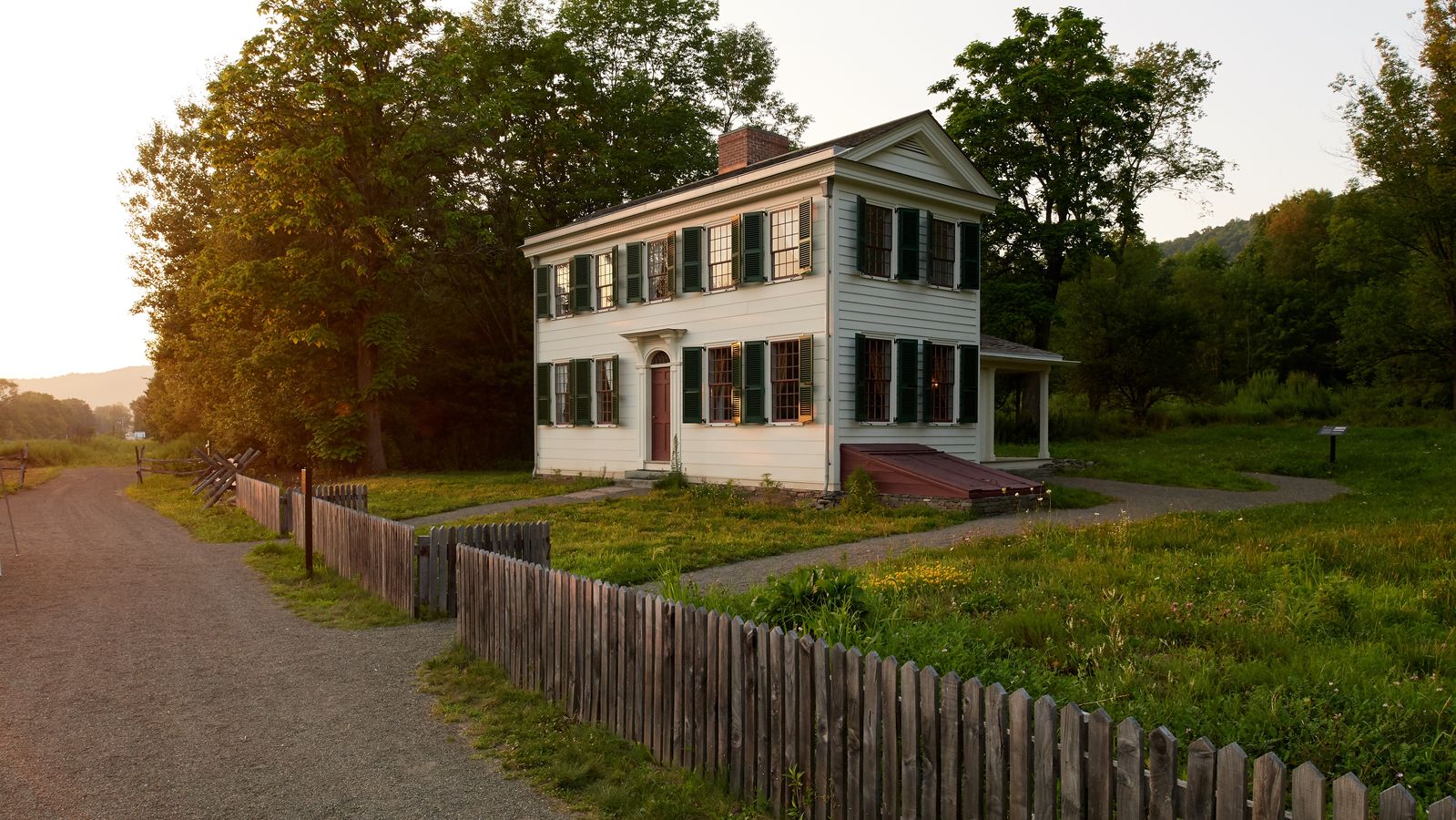 An exterior shot of farm houses in Waterloo, New York.There are trees and paths all along the way.