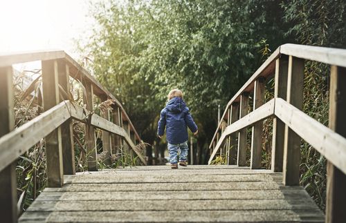 child crossing a bridge