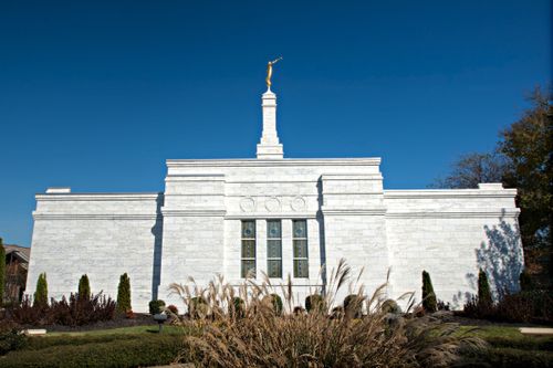 One of the sides of the Nashville Tennessee Temple, with three stained-glass windows and the spire showing overhead.