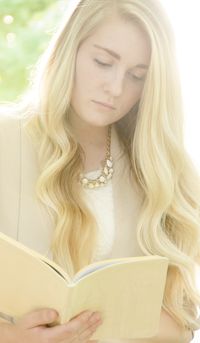 woman looking at book