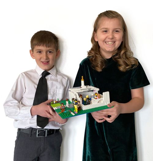 brother and sister holding a block temple