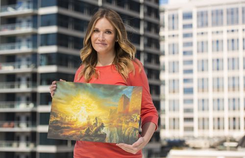 woman holding painting of Lehi’s dream