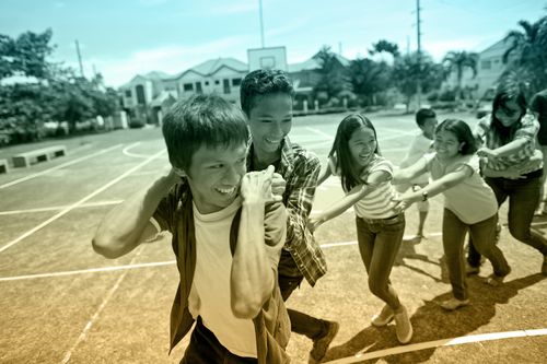 young men and young women interact during a youth activity