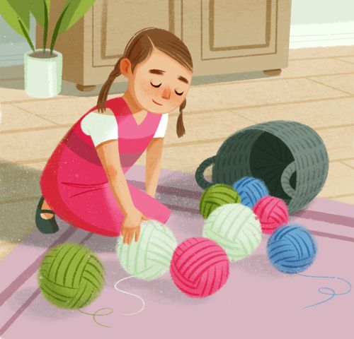 Girl picking up balls of yarn