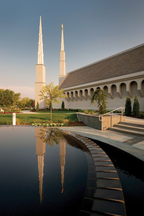 A pond on the grounds of the Boise Idaho Temple, with the temple’s spires reflected in the water.