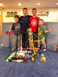 four boys building block temple