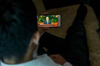 youth watching general conference on mobile device