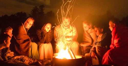 youth around a campfire