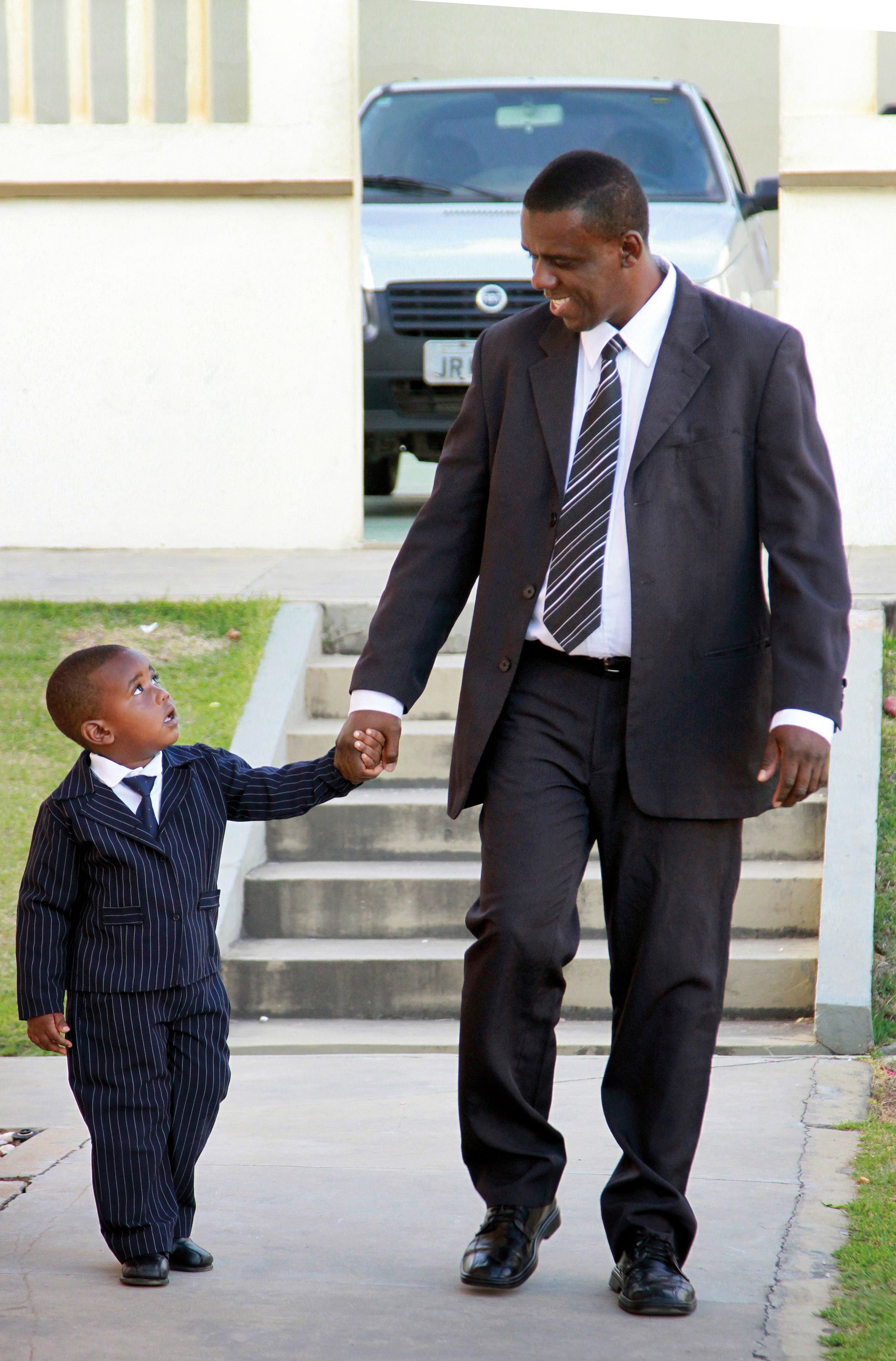 A father walks with his son during general conference.