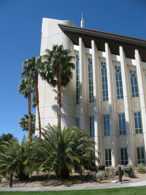 A detailed view of several of the windows on the Las Vegas Nevada Temple, with a few palm trees growing near the building.