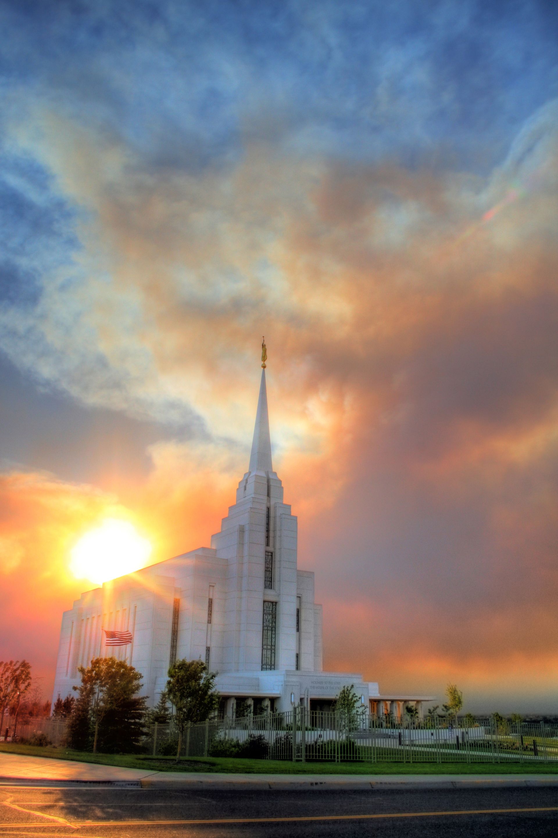The Rexburg Idaho Temple at sunset, including clouds and scenery.