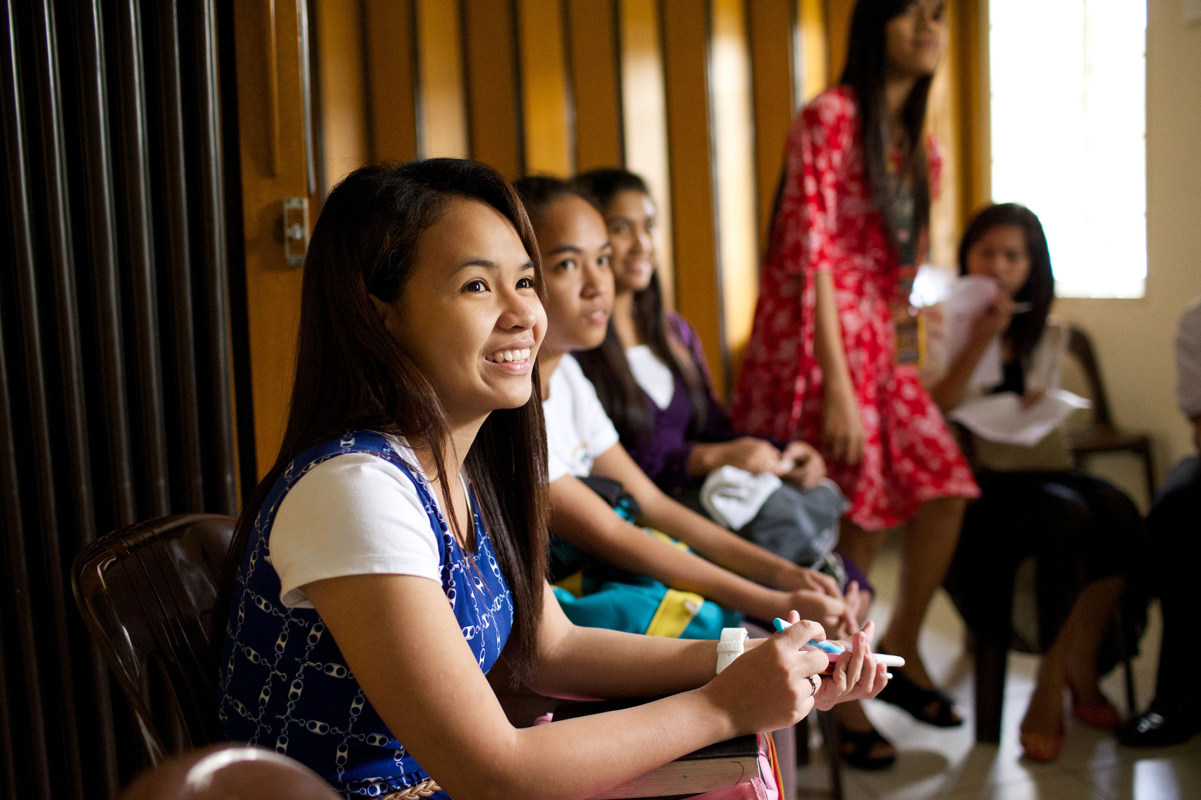 A group of young women from the Philippines sitting in a classroom at church.