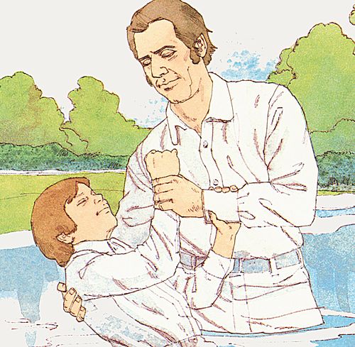 man baptizing boy