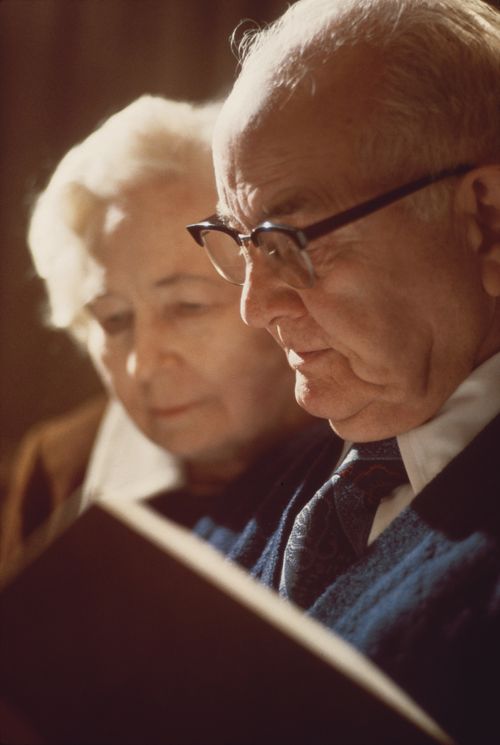 A photograph by Eldon Keith Linschoten of President Spencer W. Kimball and his wife, Camilla Kimball, looking at a book together.