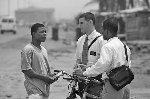 Missionaries talking to man