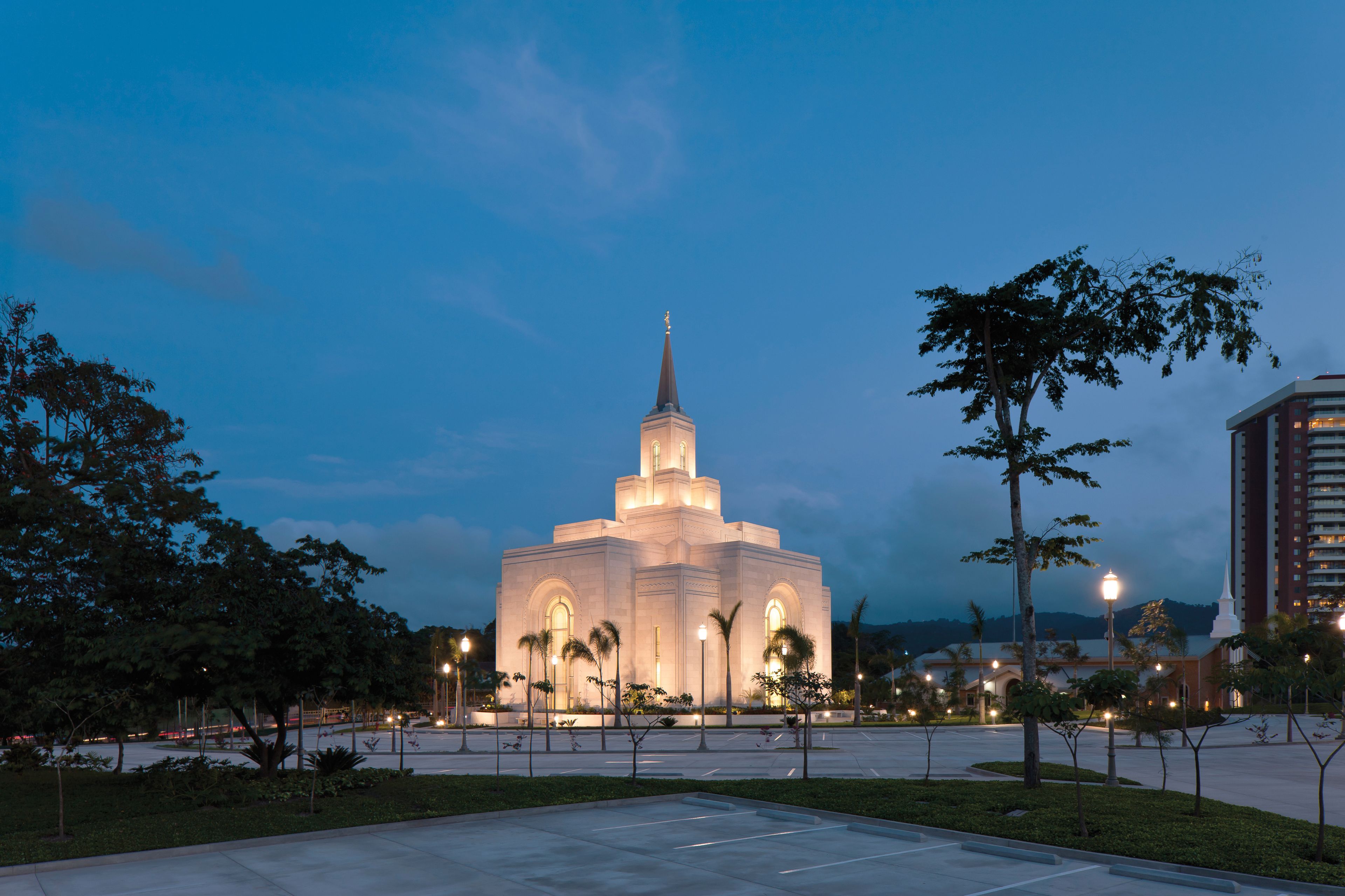 The San Salvador El Salvador Temple in the evening, including the parking lot and scenery.