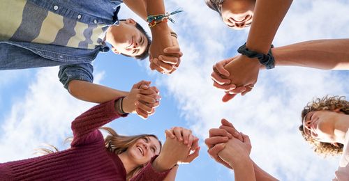 youth in a circle holding hands