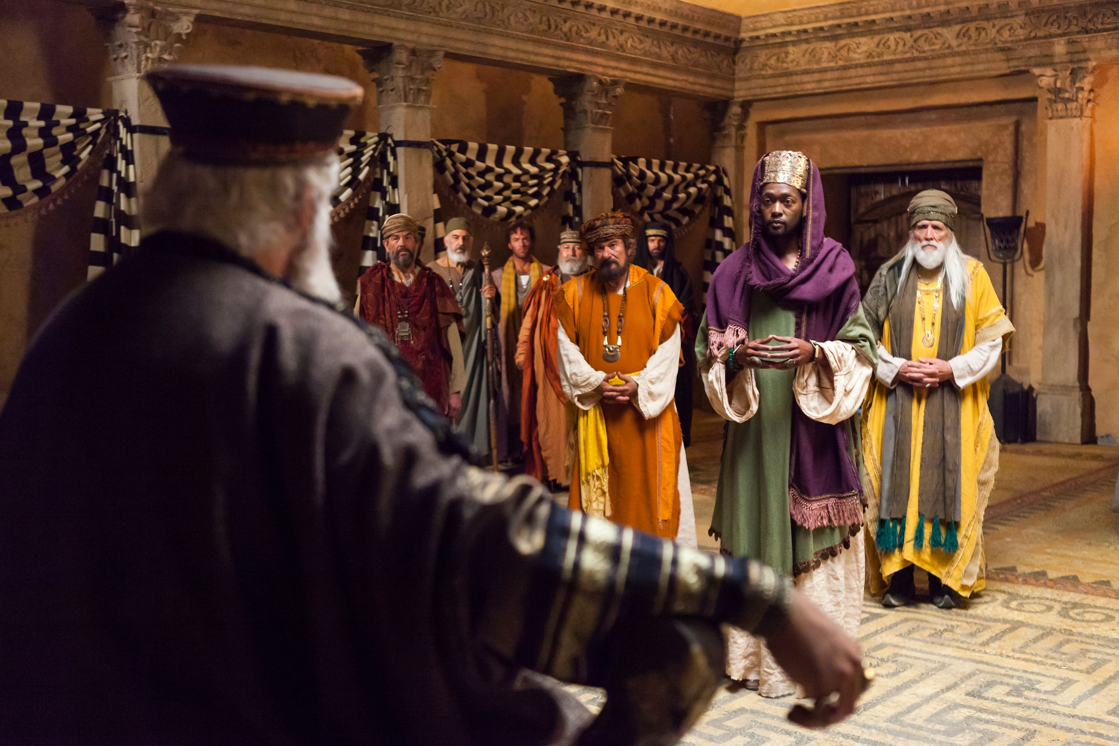 The Wise Men stand before King Herod.